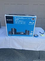 Factory-sealed Sony BDV-E300 home theater system box showing front graphics and branding