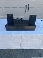 Front view of Rotel RB-970BX amplifier with two Sony bookshelf speakers placed on top, showing the overall lot contents.