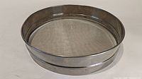Top and angle view of the large flat sieve showing the fine mesh and stainless steel frame