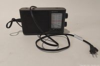 Side perspective of Sony portable radio with attached power cord visible.