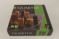 Front of the Quarto! Mini game box showing wooden game pieces on the board with the Gigamic logo and age/players indicator.