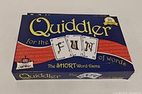 Front view of Quiddler word game box with colorful design and 'FUN' spelled on card images