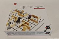 Quoridor Mini board game box front showing wooden pawns and wooden walls on a grid board image