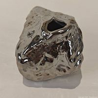 Silver-tone irregular rock-shaped stem vase, front angle showing small opening for single flower