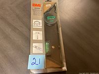 Photo of BMI Universal Level tool in original packaging showing front and side views with instructional illustrations.