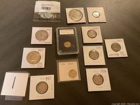 Complete view of the coin lot displaying 12 coins, mainly U.S. silver coins with years ranging from 1887 to 1983, some in protective holders.