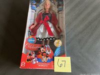 Full view of the boxed Disney Barbie 30th Anniversary doll showing box front with Disney celebration graphics, Mickey and Minnie Mouse images, and the doll inside in her outfit.