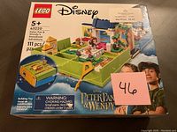 Photo of sealed LEGO box showing the front of the Peter Pan & Wendy Storybook Adventure set with 111 pieces, age 5+. Clear LEGO and Disney branding, colorful storybook-themed playset shown on box art.
