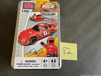 Front view of unopened Mega Bloks NASCAR die-cast set box showing red No. 8 car, driver figure, and accessories