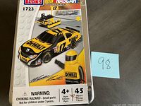 Box front showing unopened Mega Bloks NASCAR Matt Kenseth car set, yellow and black DEWALT race car model with number 17, small construction accessory and figure, labeled 45 pieces and age 4+.