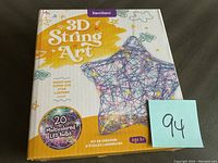 Front view of the Dan & Darci 3D String Art box showing star lantern and 20 multicolored LED bulbs.