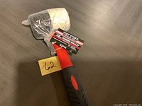 Photo of new Tuff Stuff 16 oz rubber mallet with black and red handle and dual-headed rubber mallet head wrapped in plastic.