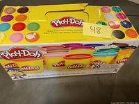 Play-Doh Super Color Pack box with 20 colors showing titles and images of the tubs, box is damaged