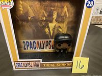 Photo shows Tupac Shakur Funko POP! number 28 in original box with 2Pacalypse Now album background artwork.