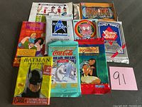 Full view of 10 unopened non-sports trading card packs arranged showing front artwork and branding.