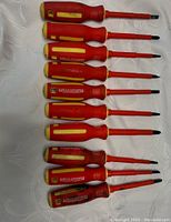 Top-down photo showing 10 Mastercraft screwdrivers laid out with red and yellow handles, assorted sizes of flathead and Phillips tips visible.
