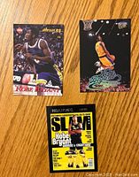 Three Kobe Bryant basketball cards front view, showing vibrant images of Kobe in action and card details.
