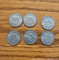 Top side (reverse) of six 1942 Canada nickel coins showing beaver design and date 1942