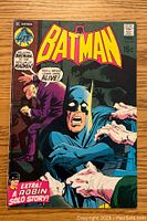 Front cover of Batman comic book issue 229 showing Batman and multiple hands grabbing him, with text about a Robin solo story and Batman at the Asylum of Death.