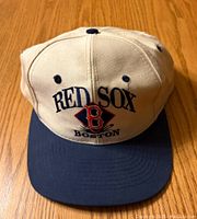 Front view showing beige crown with navy blue brim and embroidered Red Sox Boston logo.