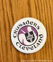 Front side of the vintage Cleveland Crusaders hockey button showing team logo and text.