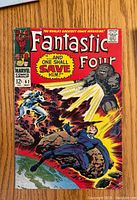 Front cover of Fantastic Four #62 comic book, showing colorful characters and title with the tagline "... and one shall save him!"
