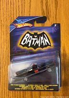 Front view of sealed Hot Wheels 1989 Batmobile toy in original packaging, showing Batman logo and toy car.