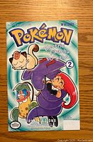 Front cover of the Pokémon Electric Pikachu Boogaloo comic book issue number 2, showing main characters including Meowth, Espurr, and Jessie from Team Rocket.