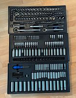 Full view of socket set laid out in trays showing all included ratchets, sockets, and accessories except one missing 5mm socket.