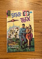 Front cover of Star Trek comic book issue #32 by Gold Key showing colorful artwork featuring Captain Kirk and other characters.