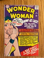 Front cover of the Wonder Woman comic book showing title and cover art with text about the story and features.