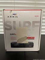 Front view of the Arris Surfboard 3.0 SBV3202 cable modem box with torn label on front.