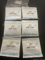Six sealed Frog Jump Start packets laid out in two rows of three on a flat surface, showing front packaging with logo and instructions.