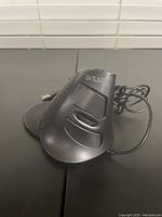 Side angled view showing textured grip, USB wire, and ergonomic shape.