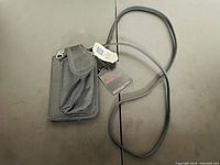 Photo of Gap black fabric mini mobile bag with long strap and front pouch with flap.