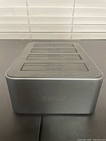 Front view of the Orico 5-bay HDD cloner dock showing the brushed aluminum case with ORICO logo.