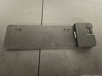 Top-down view of the black rectangular HP Ultraslim docking station with visible HP logo and connector slots.