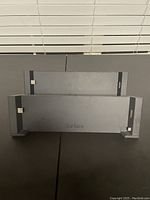 Two Microsoft Surface docking stations placed on a black surface showing the front view with the 'Surface' branding.