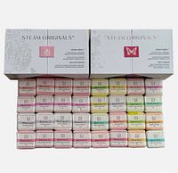 Two unopened boxes of Steam Originals shower steamers showing rows of individually wrapped steam cubes in multiple blends and colors.