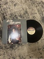 Front cover of All The Right Moves soundtrack album and vinyl record beside it.