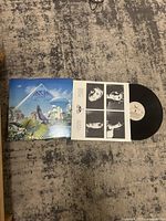 Vinyl record disc with album cover and inner sleeve showing the layout and artwork.