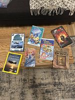 Overview of the collection showing DVDs and VHS tapes on a wooden table with some packaging visible.