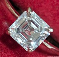 Close-up of square Asscher-style diamond face in four-prong setting