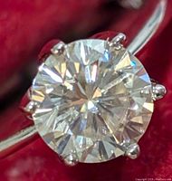 Close-up top view of round brilliant moissanite in six-prong setting