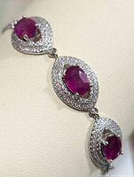 Close-up of the bracelet's ruby and cubic zirconia stones in a leaf-shaped design.