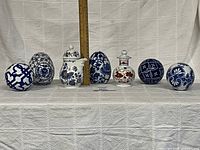 All seven ceramic pieces lined on table