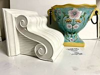 Front view of ceramic corbel and floral vase together