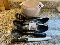 All items laid out: 3 nesting bowls, 4 utensils, knife