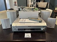 Receiver with four satellite speakers and center speaker displayed