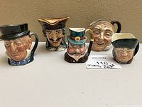 Front view of all five toby mugs displayed together